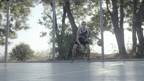 A young guy plays with a ball at dawn. Stock Footage 121145358