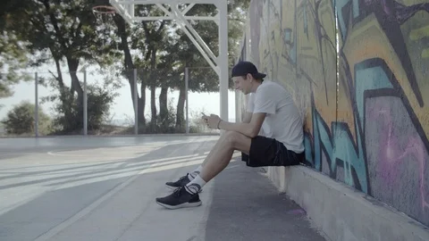 A young guy plays with a ball at dawn. Stock Footage 121287287