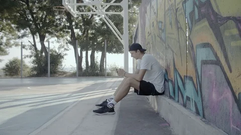 A young guy plays with a ball at dawn. Stock Footage 121287308