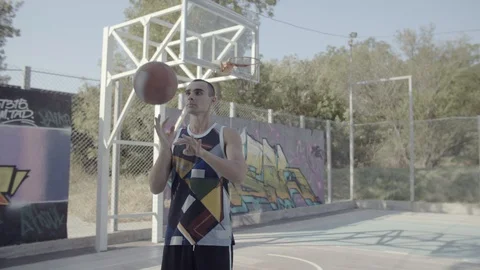 A young guy plays with a ball at dawn. Stock Footage 121287582