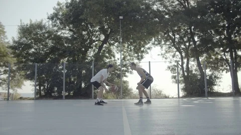 A young guy plays with a ball at dawn. Stock Footage 121362489
