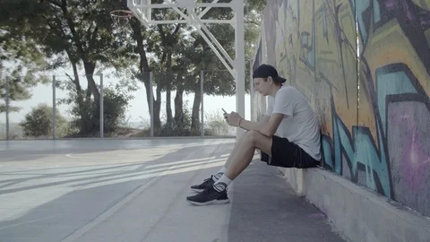 A young guy plays with a ball at dawn. Stock Footage 121362984