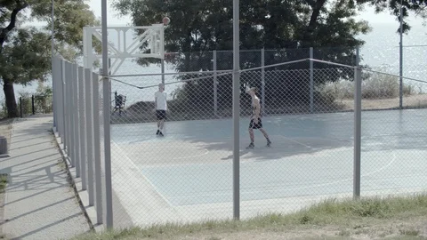 A young guy plays with a ball at dawn. Stock Footage 121363676