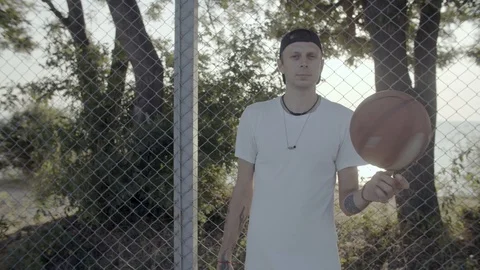 A young guy plays with a ball at dawn. Stock Footage 125094560
