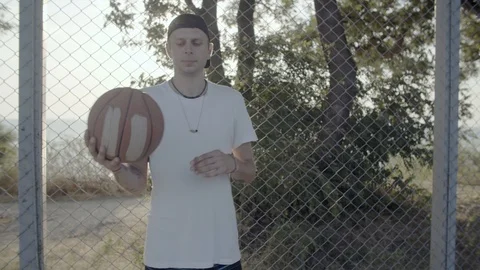 A young guy plays with a ball at dawn. Stock Footage 125094793