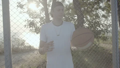 A young guy plays with a ball at dawn. Stock Footage 125095377