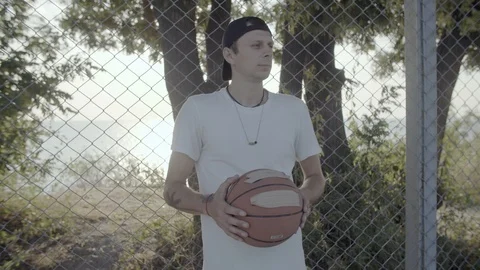 A young guy plays with a ball at dawn. Stock Footage 125096325