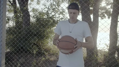 A young guy plays with a ball at dawn. Stock Footage 125096545