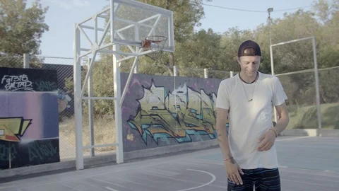 A young guy plays with a ball at dawn. Stock Footage 125097486