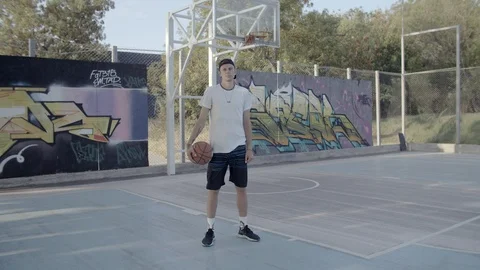 A young guy plays with a ball at dawn. Stock Footage 125132612