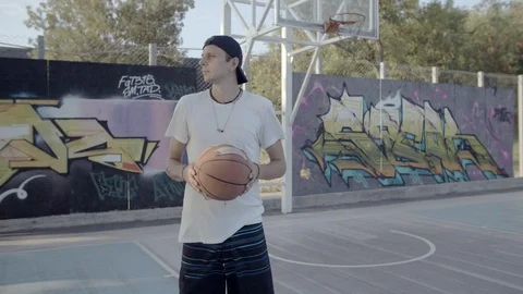 A young guy plays with a ball at dawn. Stock Footage 125132730