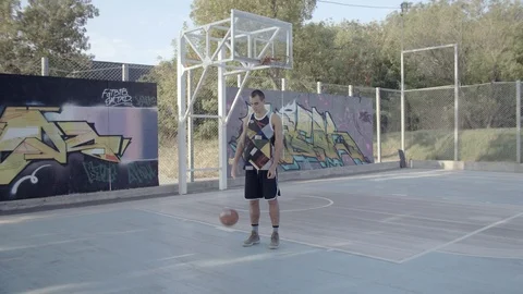 A young guy plays with a ball at dawn. Stock Footage 125133852