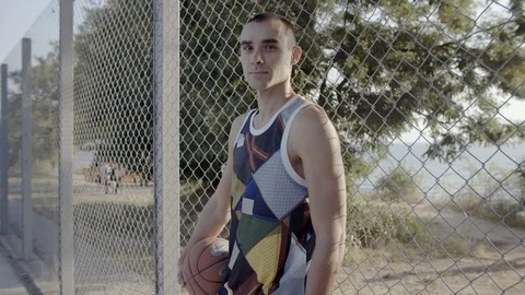 A young guy plays with a ball at dawn. Stock Footage 125134329