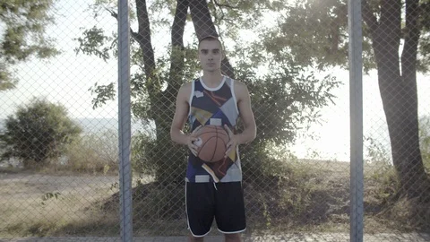 A young guy plays with a ball at dawn. Stock Footage 125134352