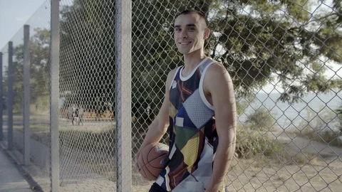 A young guy plays with a ball at dawn. Stock Footage 125134791