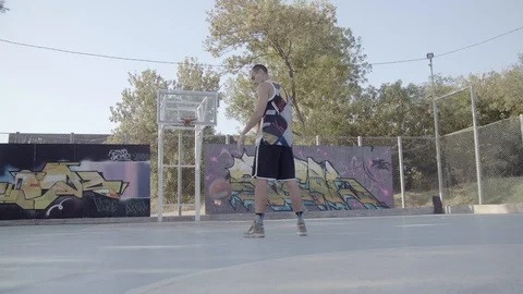 A young guy plays with a ball at dawn. Stock Footage 125180740