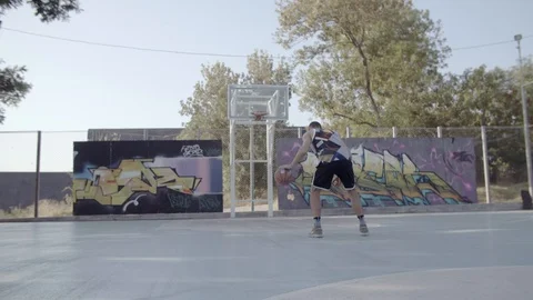A young guy plays with a ball at dawn. Stock Footage 125181006