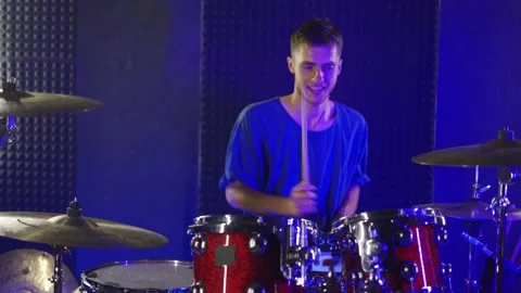 A young guy plays the drums in the studio. The camera moves forward Stock Footage 200224885