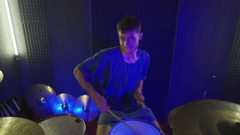 A young guy plays the drums in the studio. The camera moves forward Stock Footage 200228134