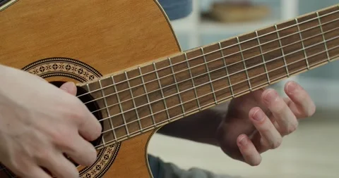A young guy plays the guitar . Close up Stock Footage 130492028