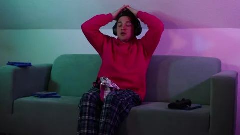 Young guy plays PS5 at night and loses game and very upset.guy lost in game Stock Footage 259489901