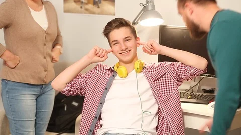 Young Guy plugged his ears is unwilling to listen to his mom and dad Stock Footage 126125784