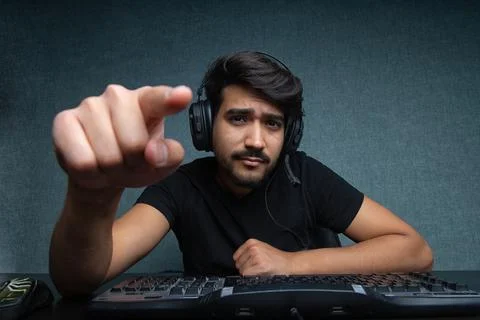Young guy points a finger at a computer screen Stock Photos