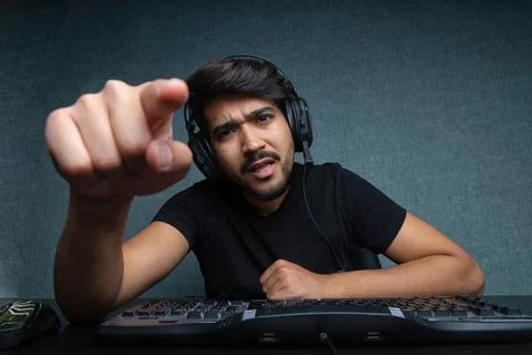 Young guy points a finger at a computer screen Stock Photos