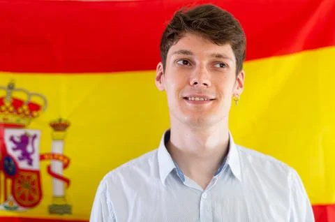 Young guy posing in front of flag of Spain Stock Photos