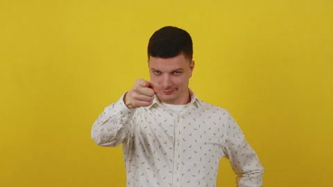 Young guy posing on a yellow background. Thinks, fantasizes, dreams and seeks Stock Footage 172055515