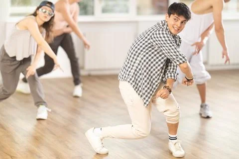 Young guy practicing basic hip hop steps in training hall 스톡 사진