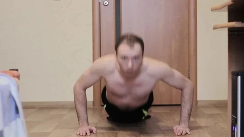 The young guy presses from the floor of the house Stock Footage 84998600
