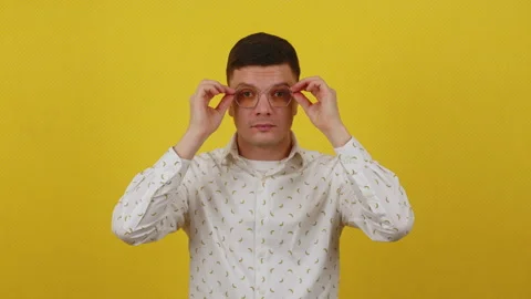 The young guy puts on glasses and begins to see well. Good vision concept Stock Footage 172055352