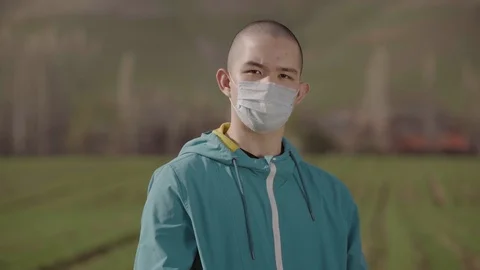 Young guy puts on a mask from the virus Stock Footage 126961894