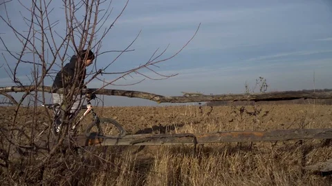 Young guy quickly descends on his bike from the hill down Stock Footage 122237155