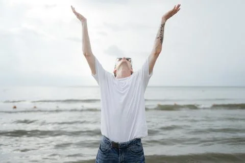 Young guy raised his hands looking up, addresses to heaven Stock Photos