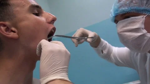 The young guy on reception at the dentist. Dental treatment Vídeos de archivo 77201112
