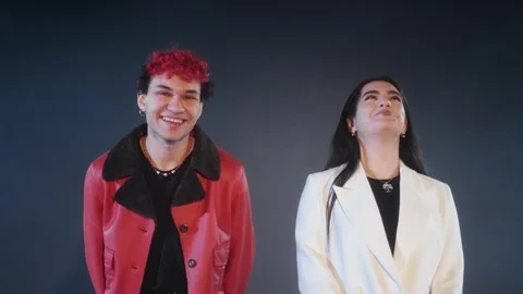 A young guy in a red jacket stands with a young girl in a white jacket Stock Footage 297625335