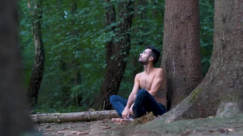 Young guy relaxes in the forest Stock Footage 115537548