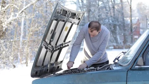 A young guy repairs a car Stock Footage 85091318