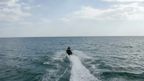A young guy rides a jet ski on the sea at high speed Stock Footage 146243901