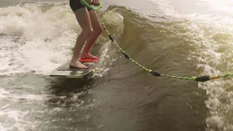 A young guy riding a board on the waves Stock Footage 158793432