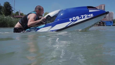 A young guy is riding a hydrocycle on the lake Stock Footage 92783161