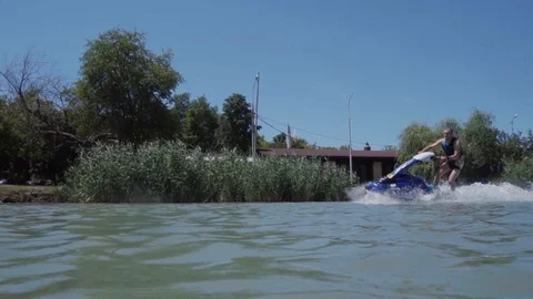 A young guy is riding a hydrocycle on the lake Stock Footage 92784231