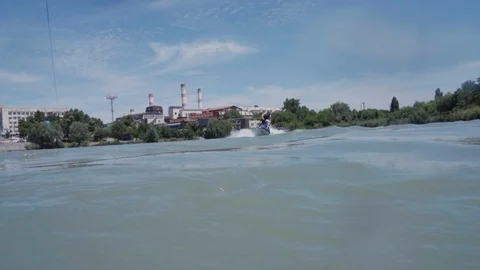 A young guy is riding a hydrocycle on the lake Stock Footage 92785113