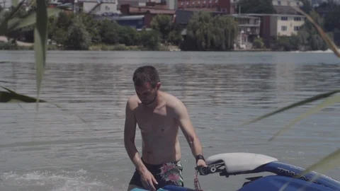 A young guy is riding a hydrocycle on the river Stock Footage 90634007