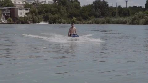 A young guy is riding a hydrocycle on the river Stock Footage 90634312