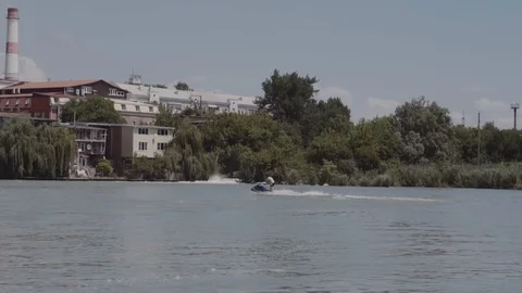 A young guy is riding a hydrocycle on the river Stock Footage 90634483