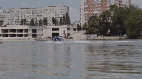 A young guy is riding a hydrocycle on the river Stock Footage 90634627