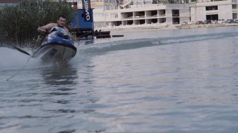 A young guy is riding a hydrocycle on the river Stock Footage 90634784
